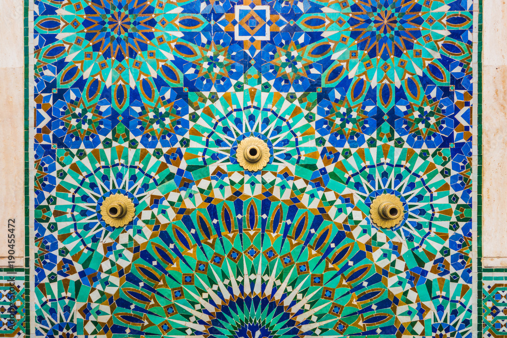 full frame shot of moroccan traditional water tap decorated with colorful shapes of mosaic in Hassan II mosque - Casablanca - Morocco