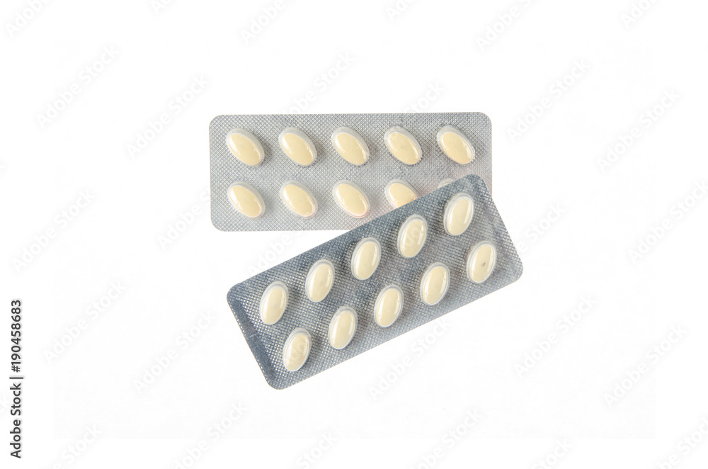 two plates of yellow tablets on white isolated background two plates of yellow tablets on white isolated background