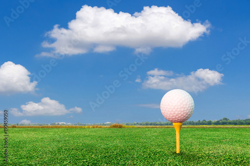 Golf ball on tee and nature background