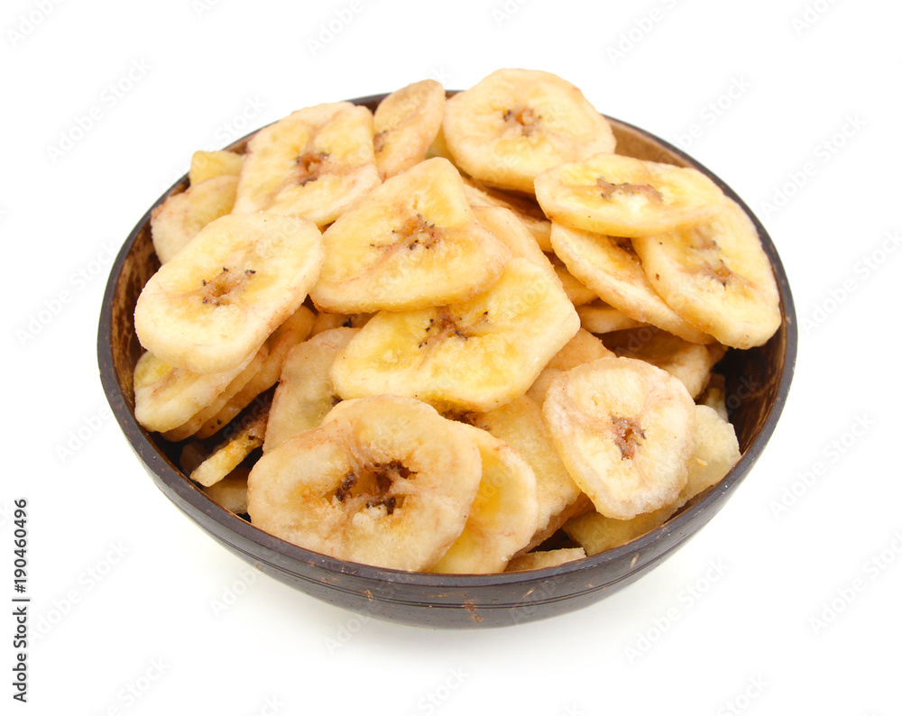 Banana chips in wood bowl on white background