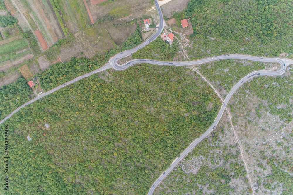 Obraz premium Aerial view on the green valley and the road in the mountains of Bosnia and Hercegovina. 