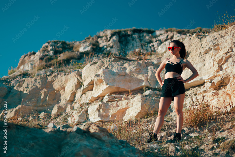 Cool Sportive Woman Wearing Sports Bustier, Shorts and Sunglasses 