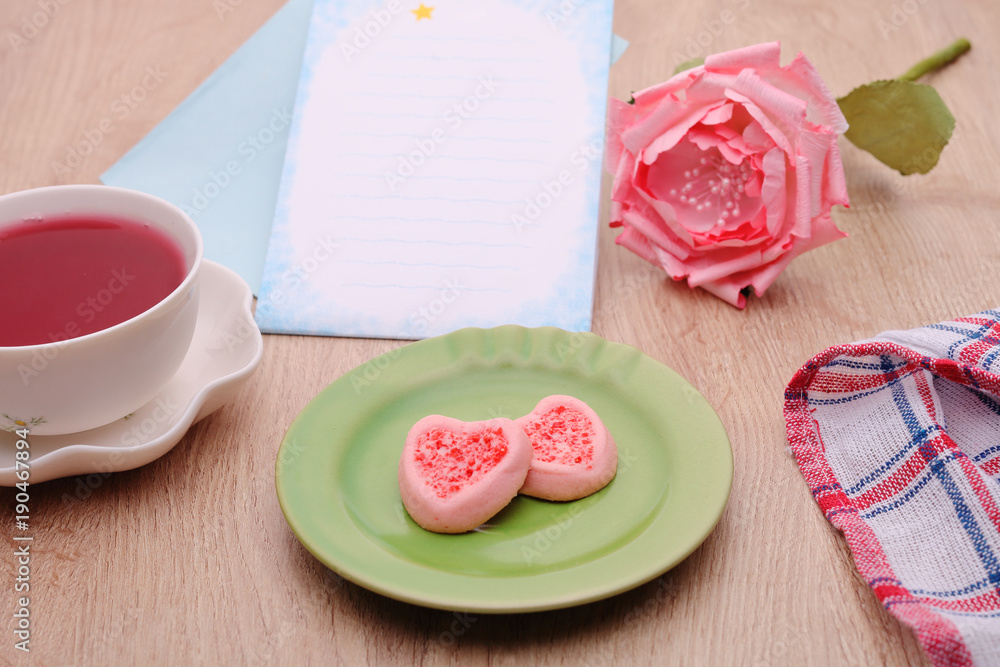 Strew berry heart cookies on green plate Strew berry heart cookies on green plate
