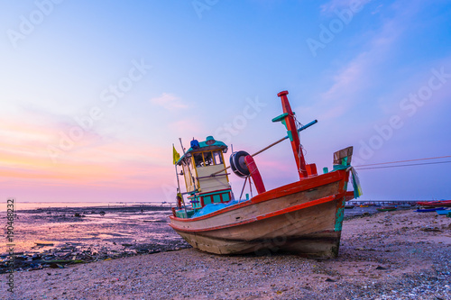 fishing boat at shore at the sunset