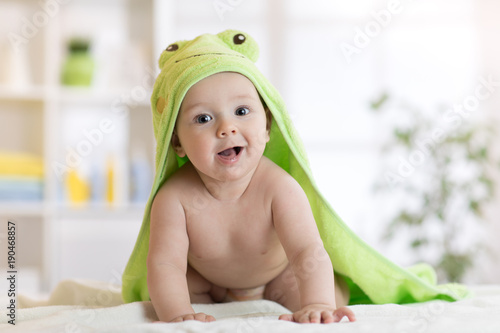 Baby boy wearing green towe...