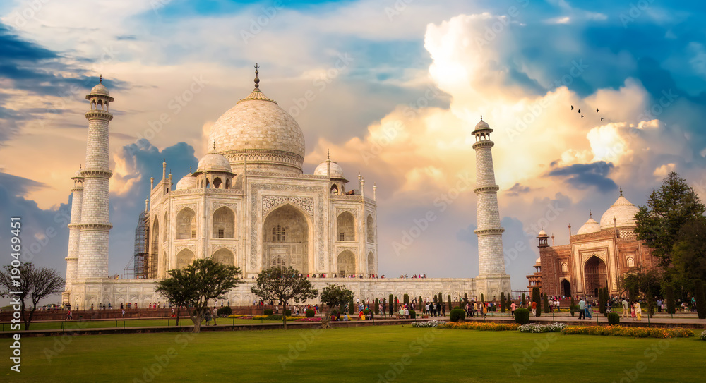 Taj Mahal Agra India historical monument at sunrise with moody sky.