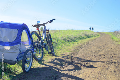 Biking in the hills with child trailer