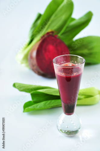 Glass Shot of Beetroot with Fresh Veggie on Background