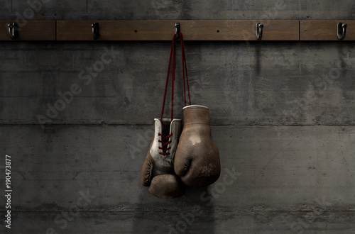 Worn Vintage Boxing Gloves Hanging In Change Room photo