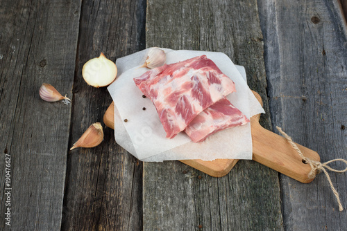 fresh pork ribs on a cutting Board, wooden background