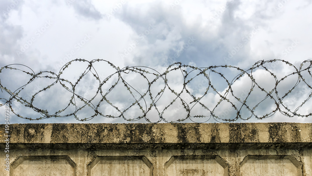 concrete wall with barbed wire