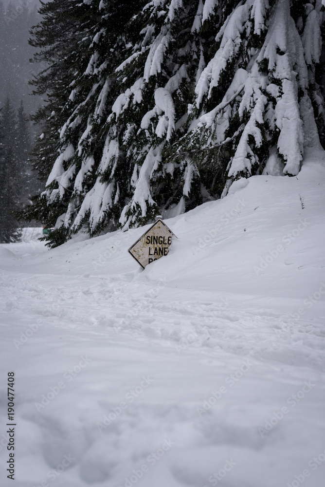 Road sign buried in deep snow