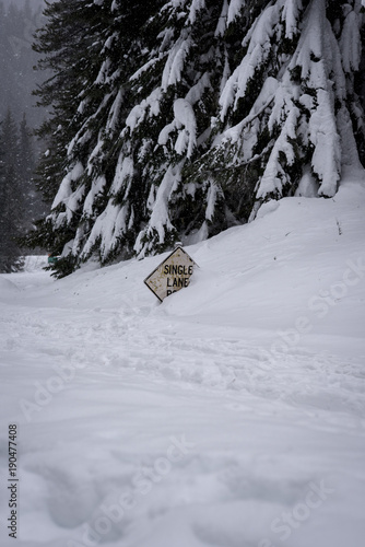 Road sign buried in deep snow