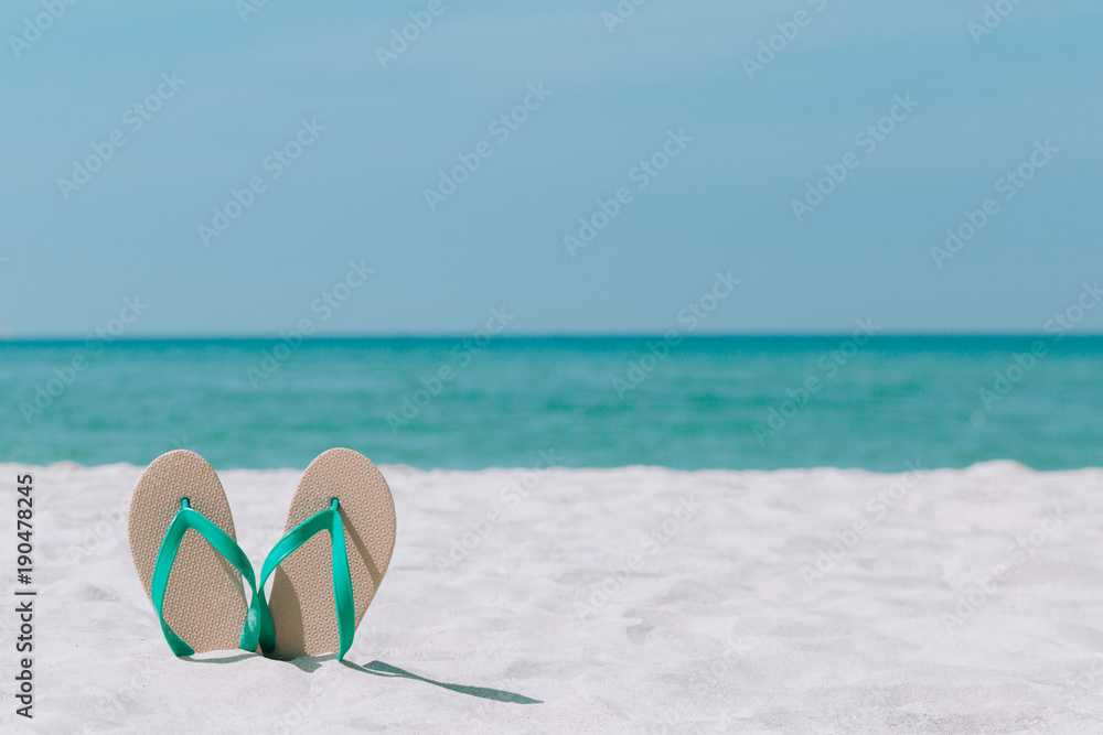 Fototapeta premium Ocean landscape And sandals on the beach. Welcome summer