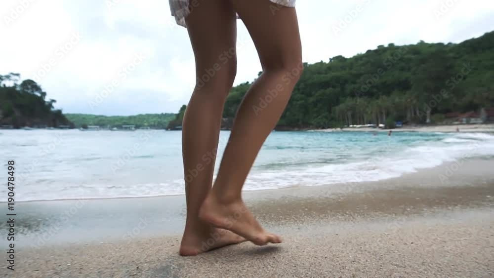 Beautiful woman legs, walking along the beach. Beautiful woman legs, walking along the beach.