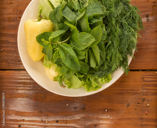 Green pepper with green salad  apple and basil on the plate placed on the rustic vintage wooden background