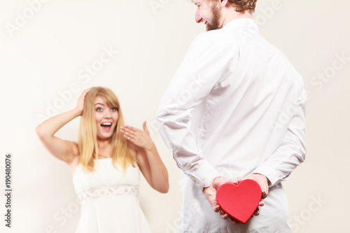 Man with heart shaped gift box for woman.