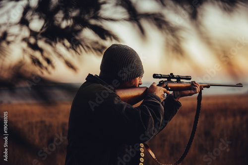 Hunter aims gun photo