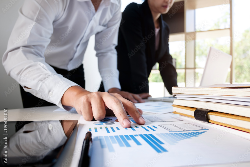 Business financier analysis data document with accountant using calculator Business financier analysis data document with accountant using calculator