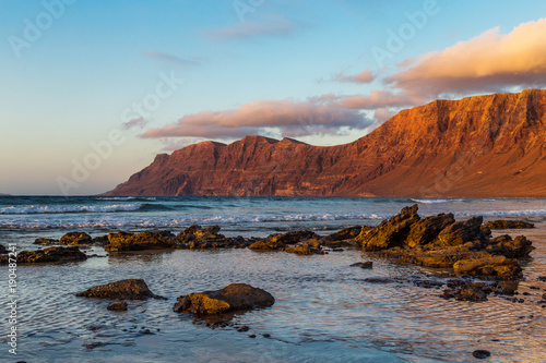 Canvas Print Sunset in Caleta de Famara, famous surfing resort on Lanzarote, Canary islands, Spain