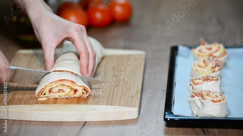 Cooking homemade Italian pizza roll on the wood table and chef photo