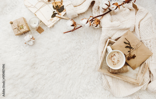 Winter cozy background with cup of coffee, warm sweater and old letters. Flat lay for bloggers photo