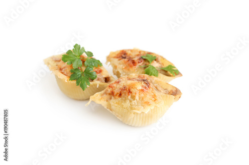 Italian pasta Conchiglioni Rigati stuffed with meat. Sprinkled with cheese. On white background