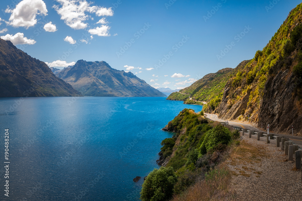 Scenic winding road along the shore at Lake Wakatipu, New Zealand, South Island
