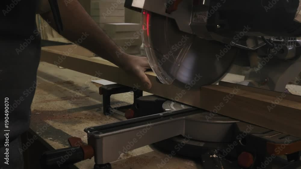 Using a chop saw to cut a piece of wood Stock Video Adobe Stock