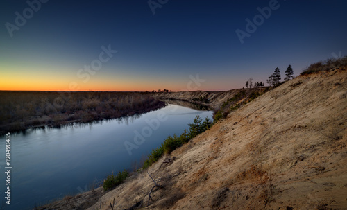 Evening landscape with a river, at sunset. Photographed in the central part of Russia. © olgapkurguzova