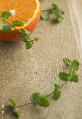Orange and mint leaves on wooden plate for fresh lemonade