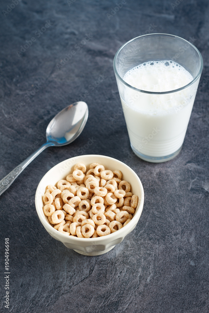 Multigrain breakfast cereal hoops in a bowl with milk Multigrain breakfast cereal hoops in a bowl with milk