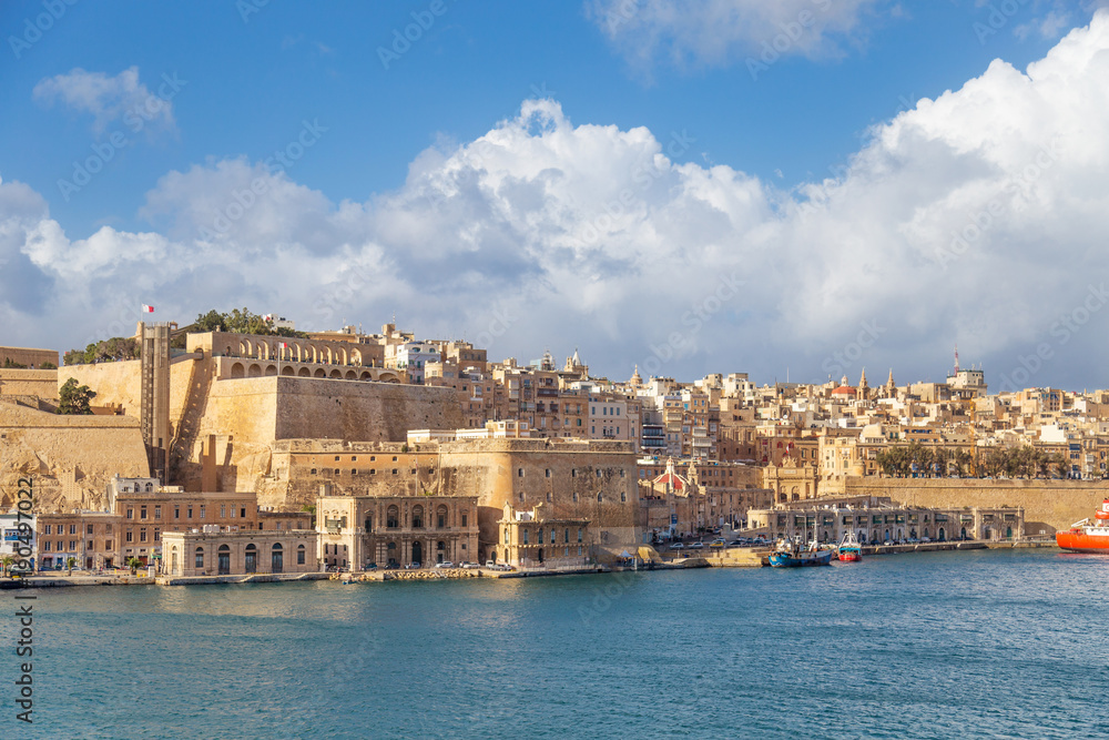 Fototapeta premium View on Valletta, capital city of Malta from the Grand Harbour with docks, The Saluting Battery and Barakka Lift.