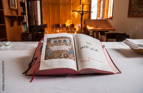 Christian Bible in Arabic language on the altar of Christian church in Aboud Village photo