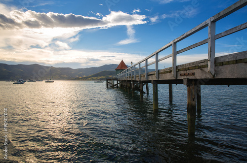 Wallpaper Mural Sunset view of wooden pier in Akaroa bay, near Christchurch, New Zealand  Torontodigital.ca
