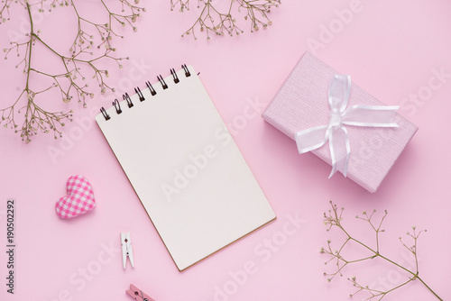 Gift box tied with pink ribbon and white flowers for mothers day