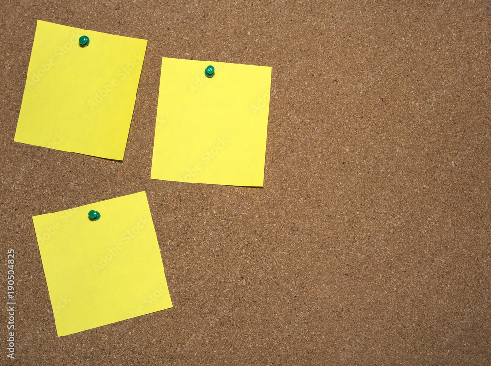 Three yellow notes papers are pinned on cork board for writing and a place for text. Three yellow notes papers are pinned on cork board for writing and a place for text.