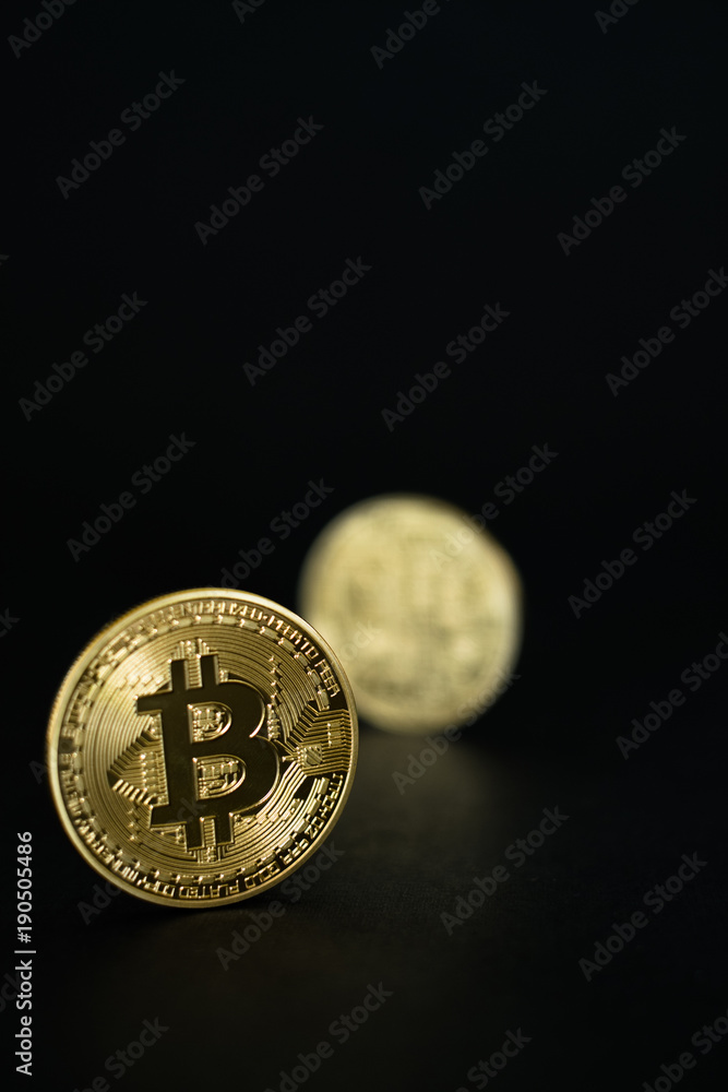 Gold Bitcoins isolated on black background Gold Bitcoins isolated on black background