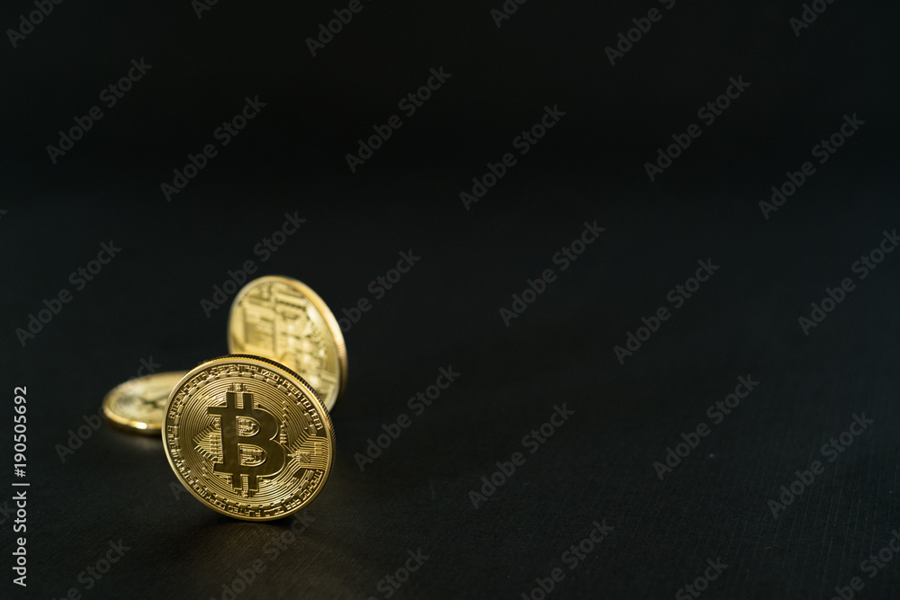 Gold Bitcoins isolated on black background