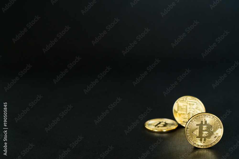 Gold Bitcoins isolated on black background