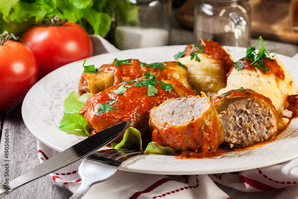 Stuffed cabbage with meat and rice served with boiled potatoes and tomato sauce Stuffed cabbage with meat and rice served with boiled potatoes and tomato sauce