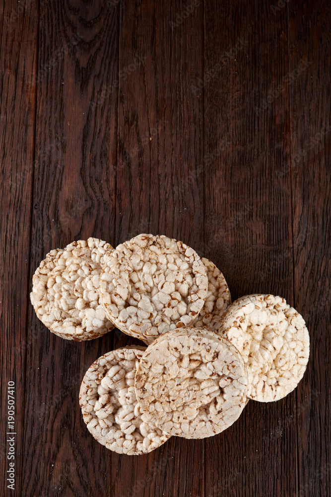 Stack of crispbreads on dark wooden table Stack of crispbreads on dark wooden table