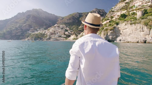 Male Model Standing On Yacht Wind Blowing Whiote Shirt Success Sunny Vacation Extereme Travel Slow Motion Shot Red Epic 8k photo