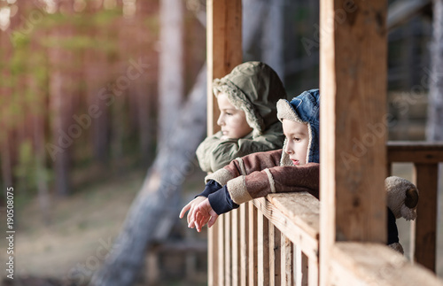 children stand on the porch of the mountain hut