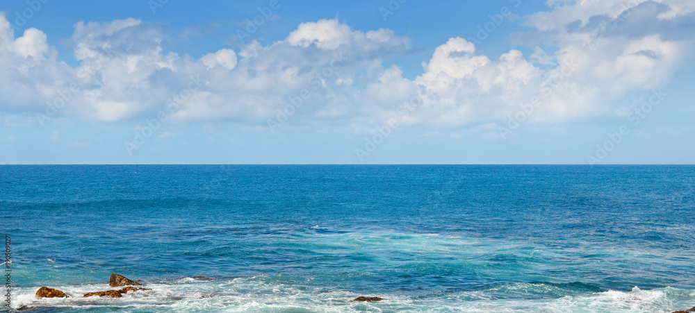 Tropical ocean, beach, high waves and blue sky.