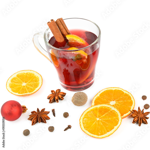 Hot red mulled wine isolated on white background with spices, orange slice, anise and cinnamon sticks. Flat lay, top view.