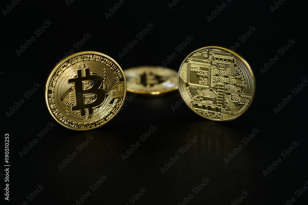 Gold Bitcoins isolated on black background