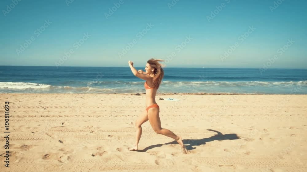happy young woman runs at manhattan beach in california. vintage filter happy young woman runs at manhattan beach in california. vintage filter