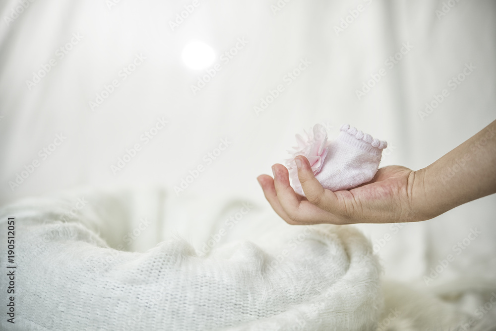 Fototapeta premium Baby shoes in hand