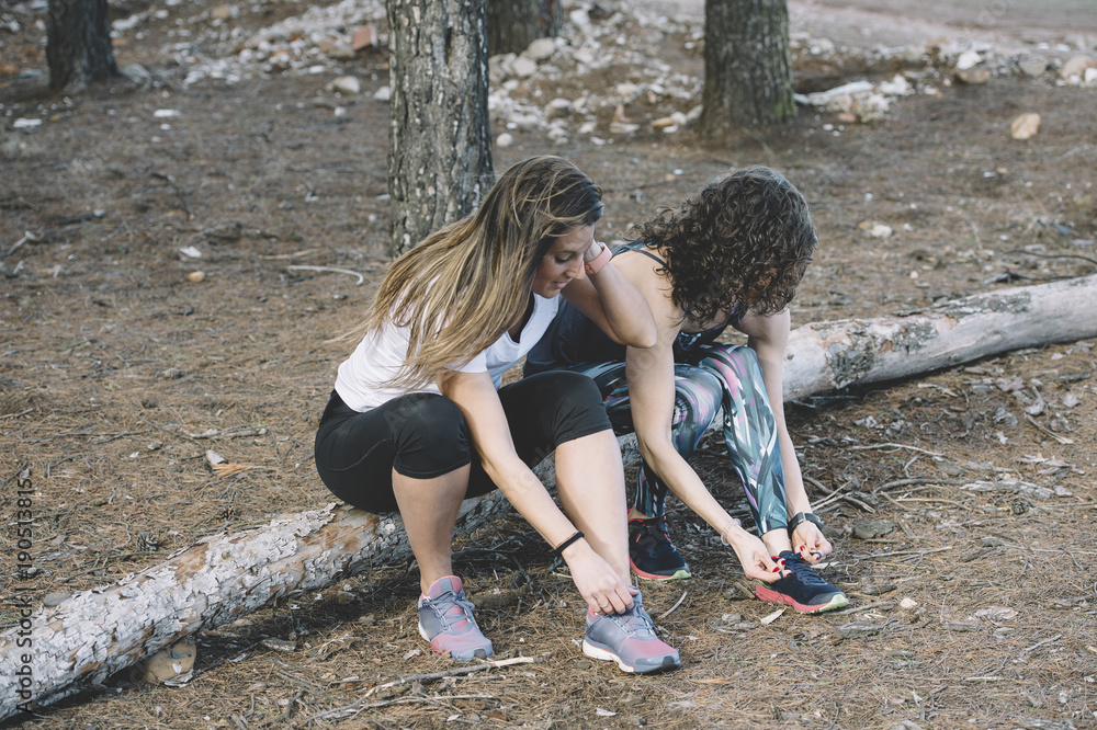 two beautiful women preparing for running two beautiful women preparing for running